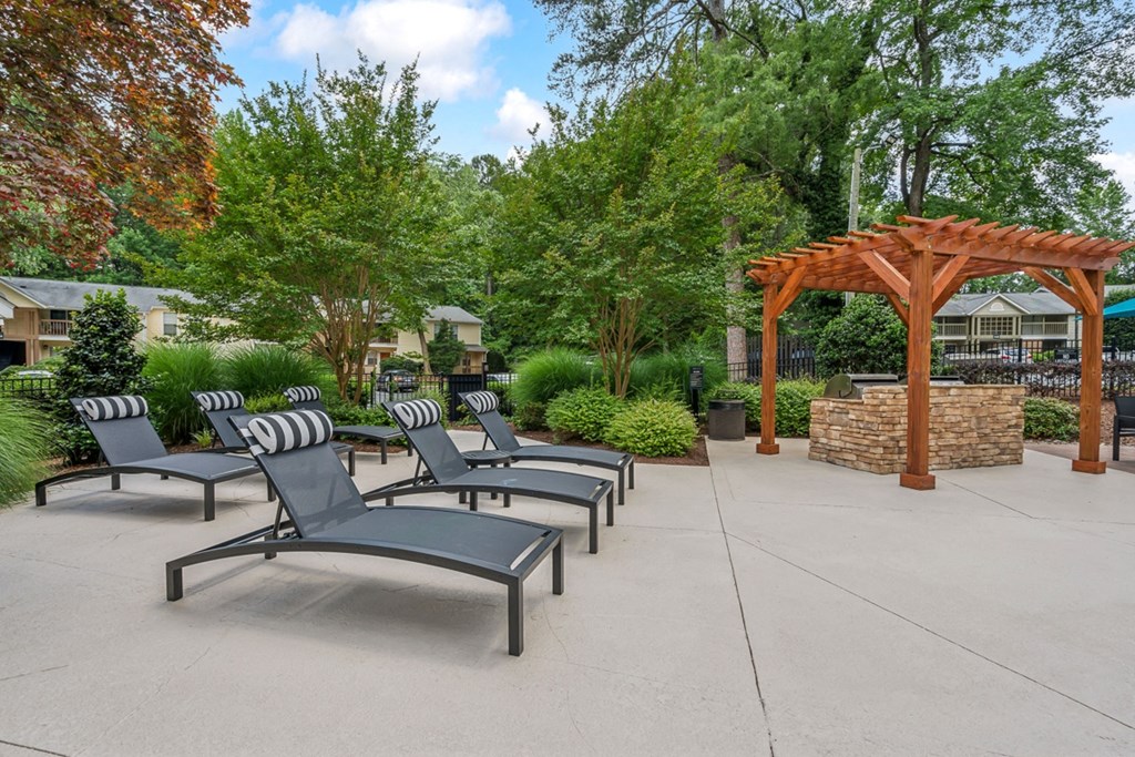 a group of lounge chairs sitting in front of a pavilion