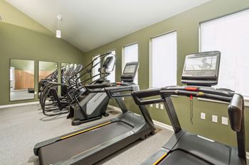A gym with treadmills and exercise bikes.