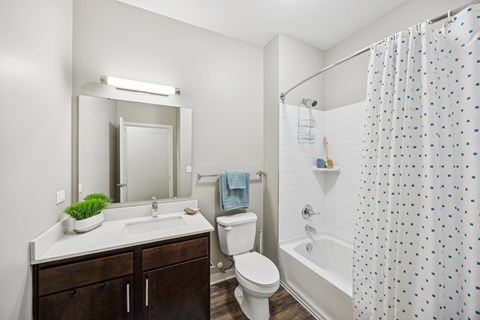 A bathroom with a white sink and a white toilet.