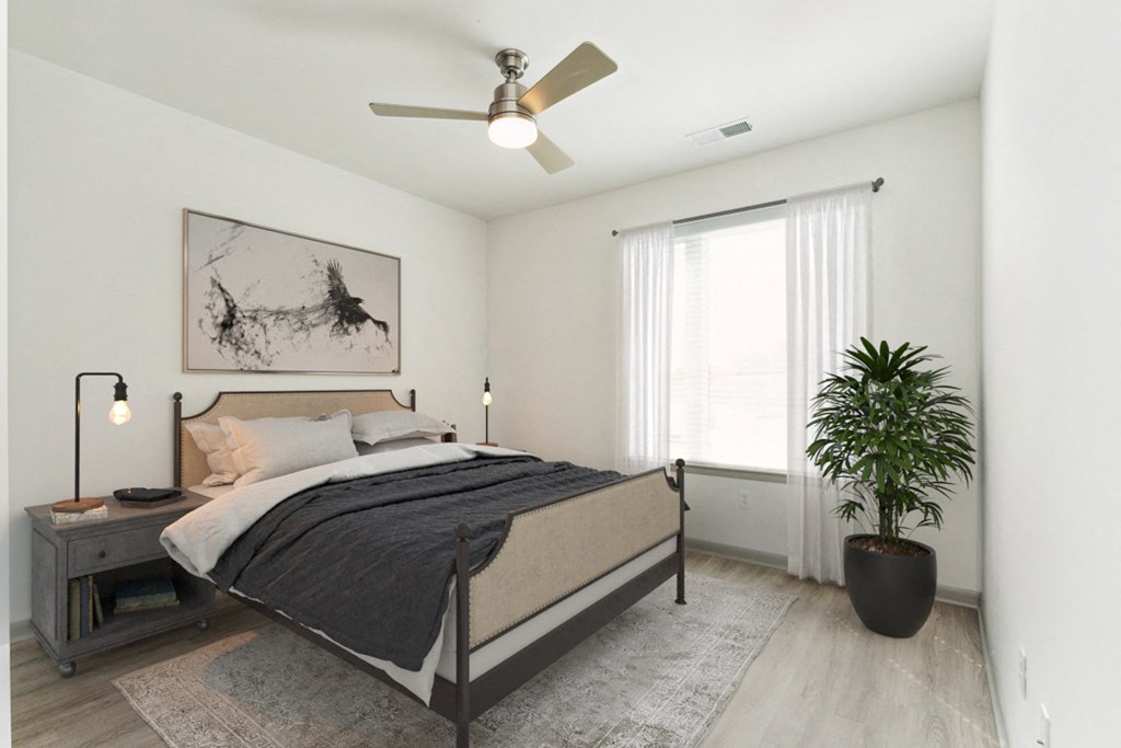 a bedroom with a bed and a ceiling fan