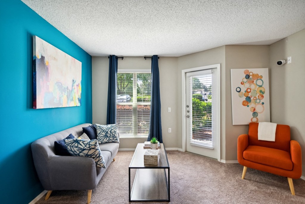 a living room with a blue wall and a couch and a table