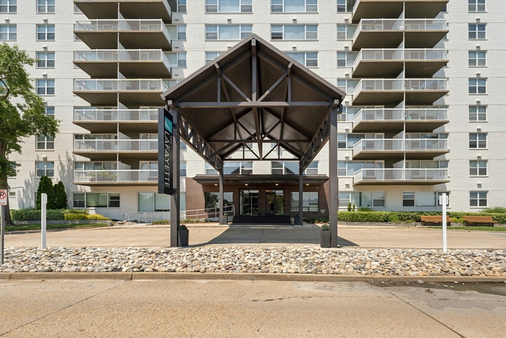 the entrance to an apartment building with awning in front of an empty street at The Lafayette Apartments, Colonial Place, Norfolk