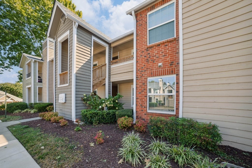 A building with a red brick wall and a balcony at Willow Ridge Apartments, North Carolina, 28210