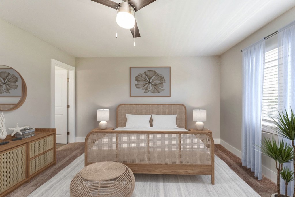 a bedroom with a bed and a ceiling fan at The Courtyards of Chanticleer Apartments, Virginia, 23451