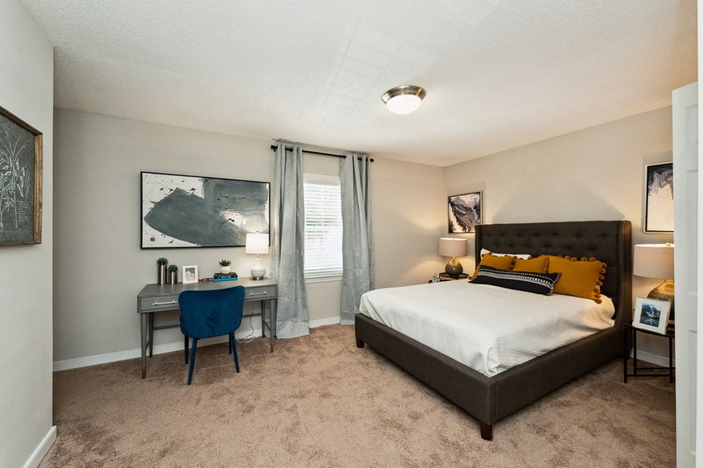 a bedroom with a bed and a desk and a window at Hyde Park Townhomes, PRG Real Estate Management, Chester, VA