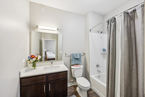 A bathroom with a sink, toilet, and shower.