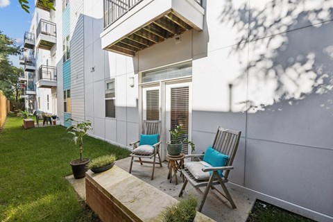 A small patio with two chairs and a table.