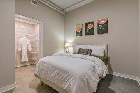 A bedroom with a white bed and a green headboard at The Carousel Apartments, Richmond, Virginia