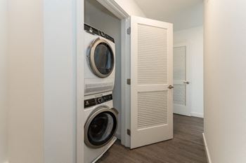 a small laundry room with a washer and dryer in a closetat South Falls Tower, Richmond, Virginia