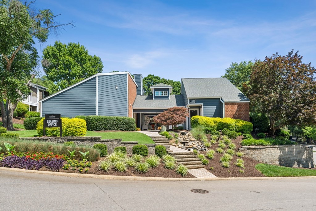 A house with a green lawn and a sign at Woodcreek Apartments, Cary, North Carolina
