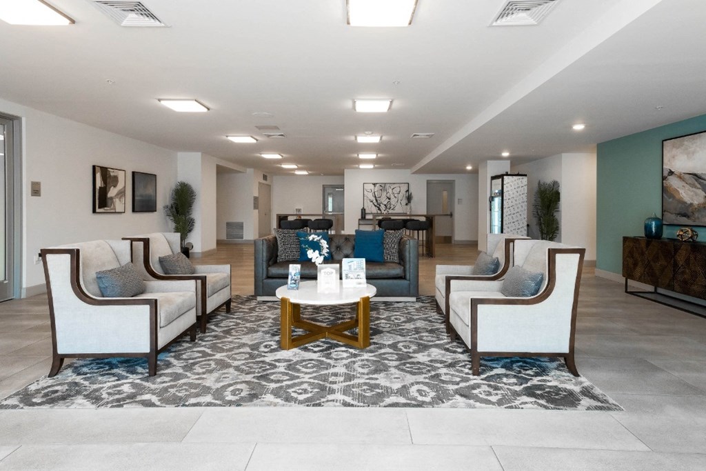 a lobby with couches and chairs and a table