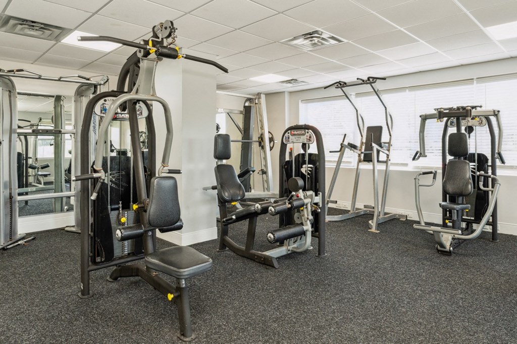 a gym with weights and other equipment in a building at The Lafayette Apartments, Colonial Place, Norfolk