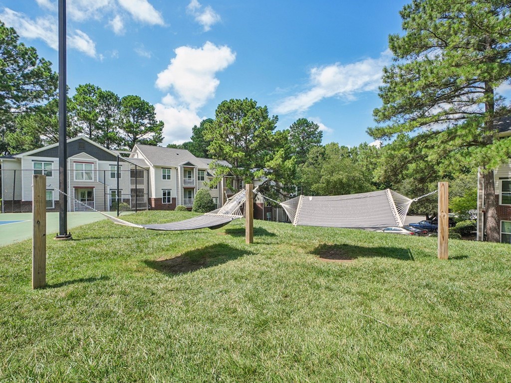 A residential area with houses and a hammock at The Falls Apartments in Raleigh NC