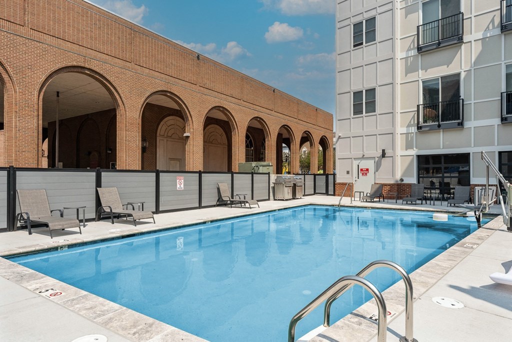 a swimming pool in front of a building at The Constellation Apartments, PRG Real Estate, Hampton, Virginia