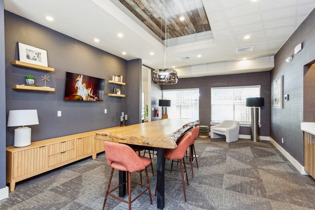 a dining room with a table and chairs and a fireplace  at Palm Crossing, Florida