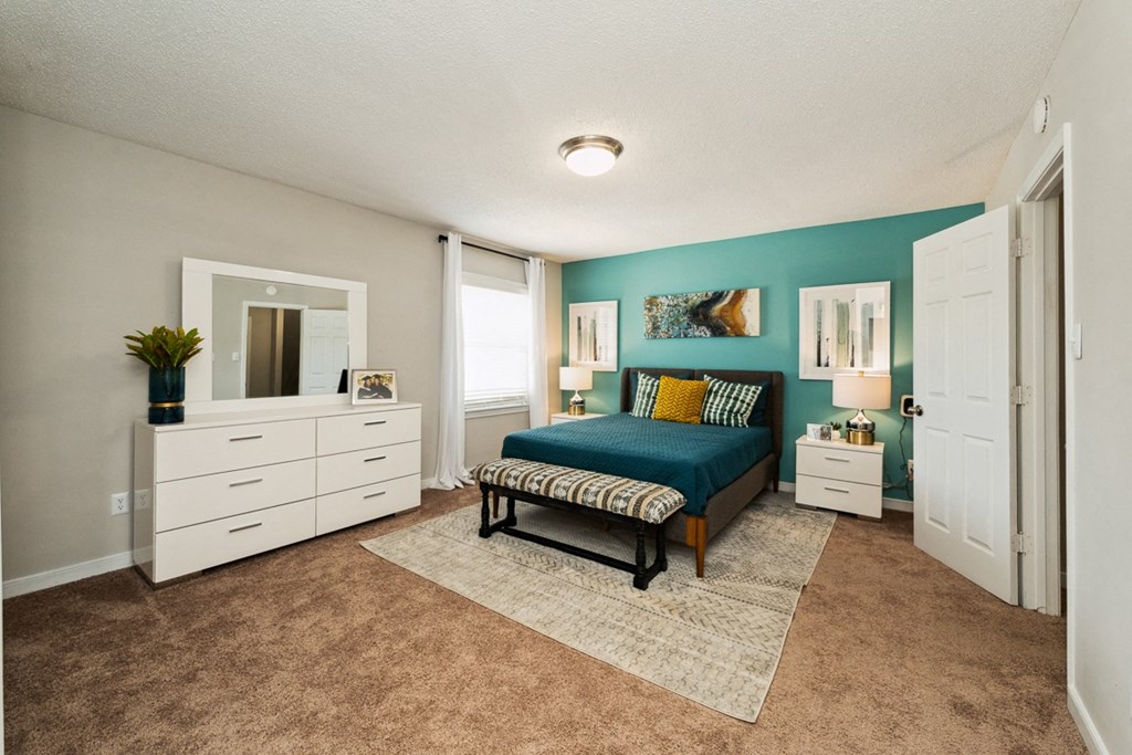a bedroom with a bed and a dresser at Hyde Park Townhomes, PRG Real Estate Management, Chester, VA