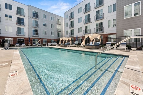 A swimming pool in front of apartment buildings at The Point Apartments on 38th, Norfolk, Virginia