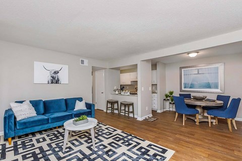 A blue couch sits in a living room with a coffee table in front of it.