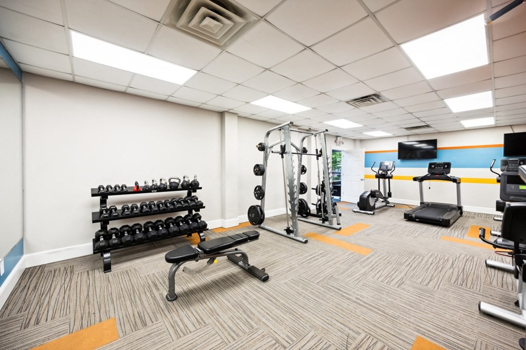 a gym with weights and other exercise equipment at the monarch apartments at River Oak Apartments, Kentucky, 40206