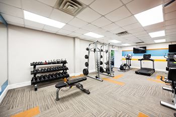 a gym with weights and other exercise equipment at the monarch apartments at River Oak Apartments, PRG Real Estate, Kentucky, 40206