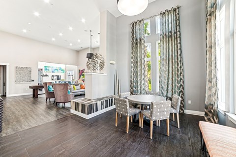 A modern dining room with a glass table and chairs at Proximity Apartments, South Carolina, 29414