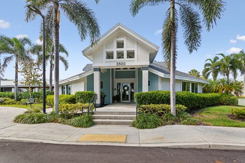 the front of a house with palm trees