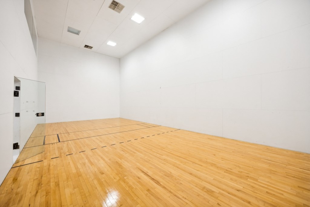 a racquetball court in a white room with wood floors at River Oak Apartments, Louisville, 40206
