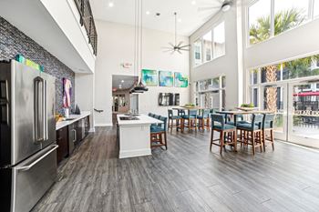 A modern kitchen with a dining table and chairs at Proximity Apartments, Charleston, SC