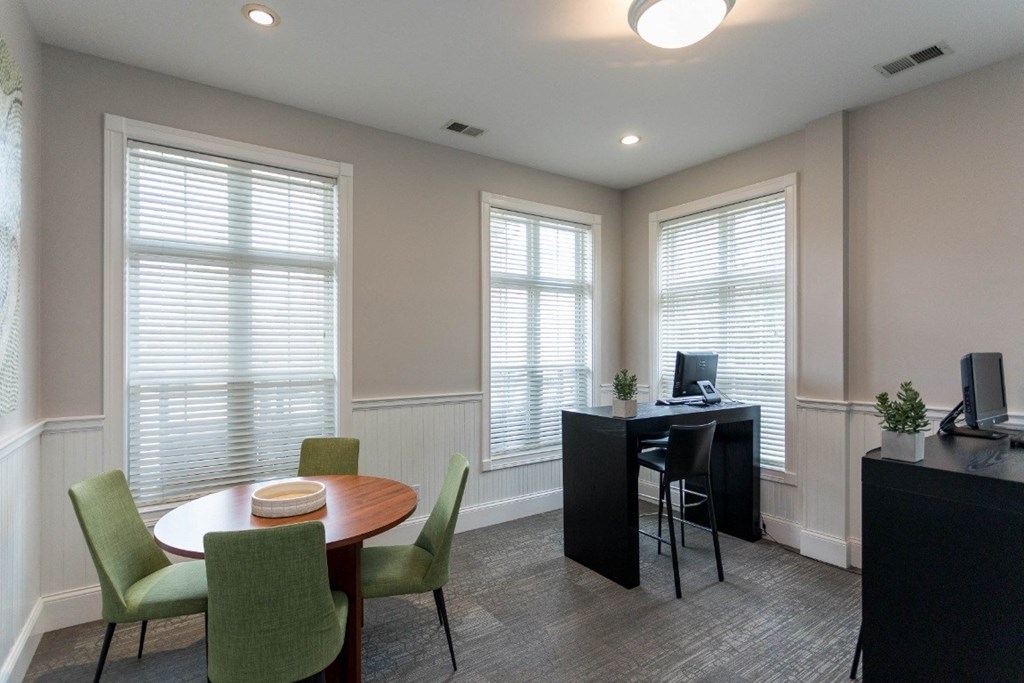 a room with a table and chairs and three windows at The Resort At Lake Crossing Apartments, PRG Real Estate, Lexington, KY