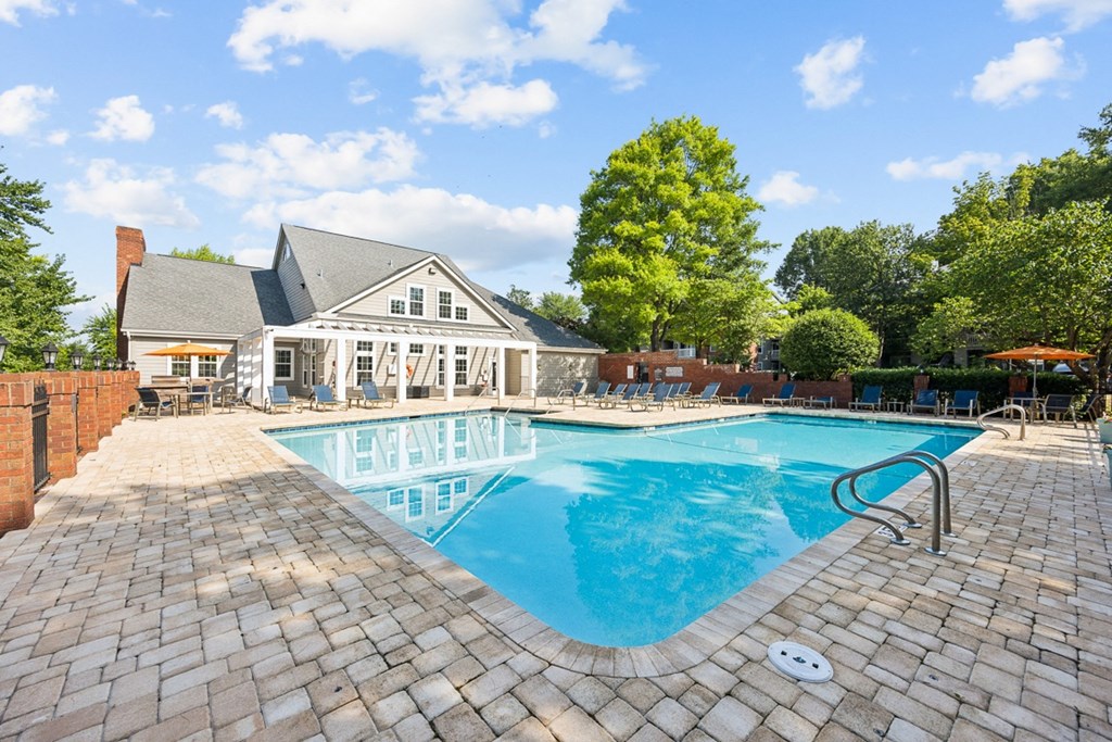 a swimming pool with a house in the background at River Oak Apartments, Louisville, KY, 40206