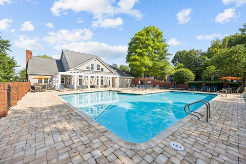 a swimming pool with a house in the background