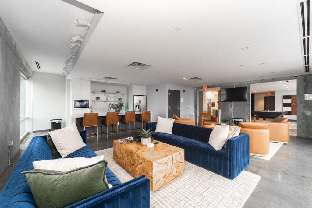 A living room with a blue couch and a coffee table.