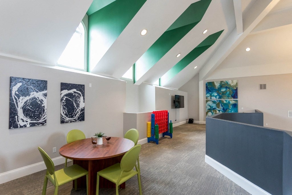 a room with a round table and green chairs at The Resort At Lake Crossing Apartments, PRG Real Estate, Lexington, KY