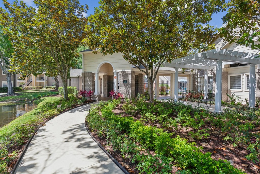 a walkway with trees and a building in the background  at Palm Crossing, Winter Garden, Florida