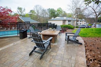 a patio with chairs and a table on a brick sidewalk at Park Ridge Estates, Durham, North Carolina