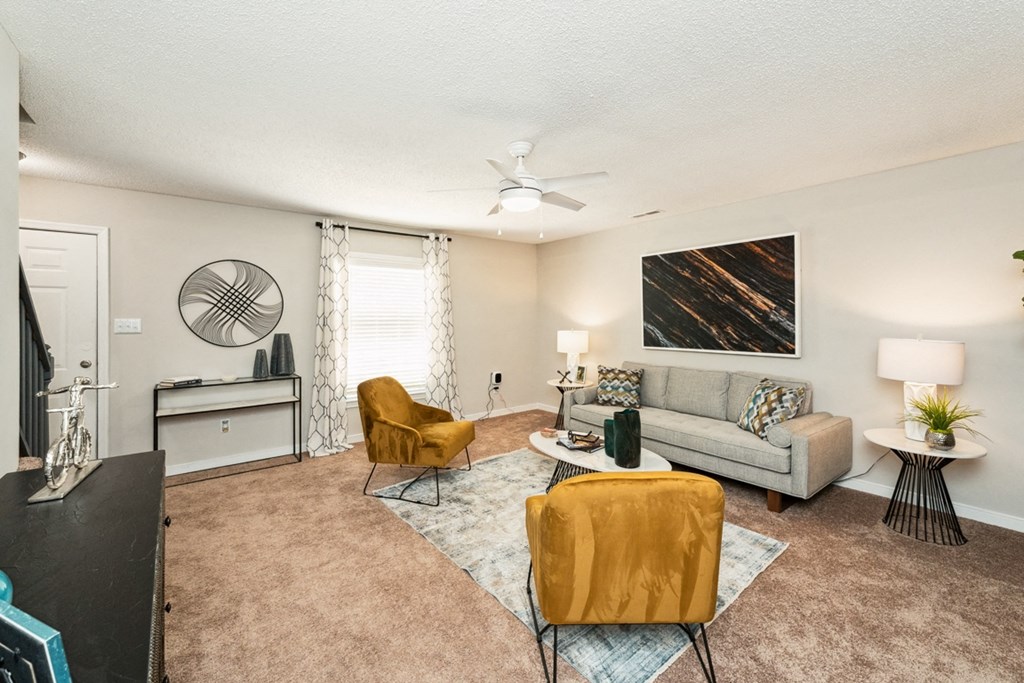 a living room with a couch and chairs and a ceiling fan at Hyde Park Townhomes, PRG Real Estate Management, Chester, VA