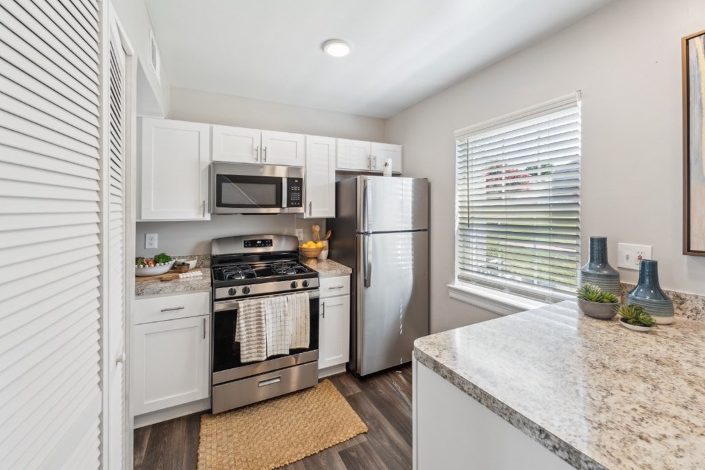 A kitchen with a refrigerator, stove, and microwave at Staples Mill Townhomes Apartments, Richmond, VA