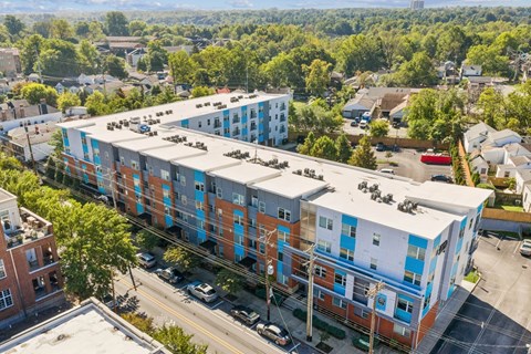 A large apartment complex with a parking lot in front.