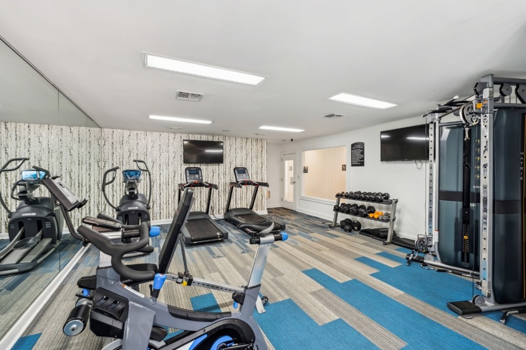 A gym with a variety of equipment including treadmills, stationary bikes, and weight machines.at Chapel View, North Carolina