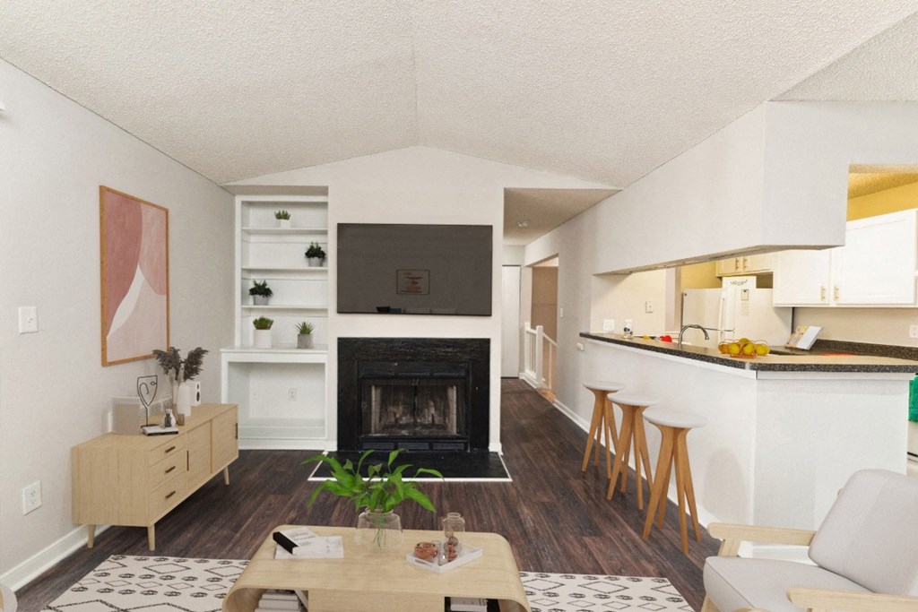 the view of a living room with a fireplace and a kitchen