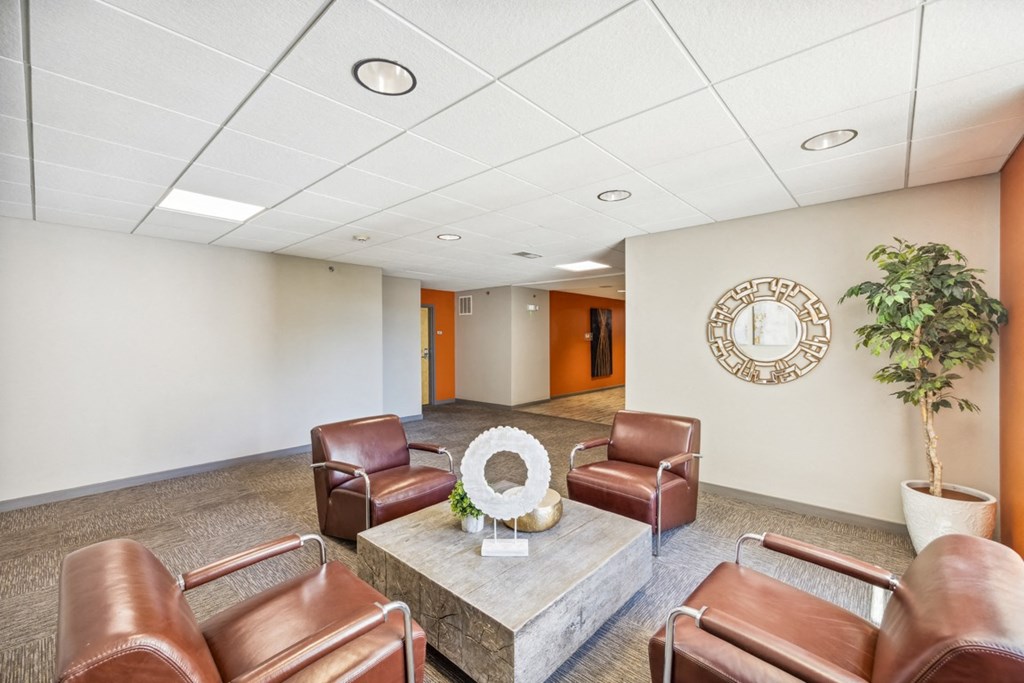 Waiting Room with Leather Chairs and a Coffee Table at 45 Madison Apartments, Missouri, 64111