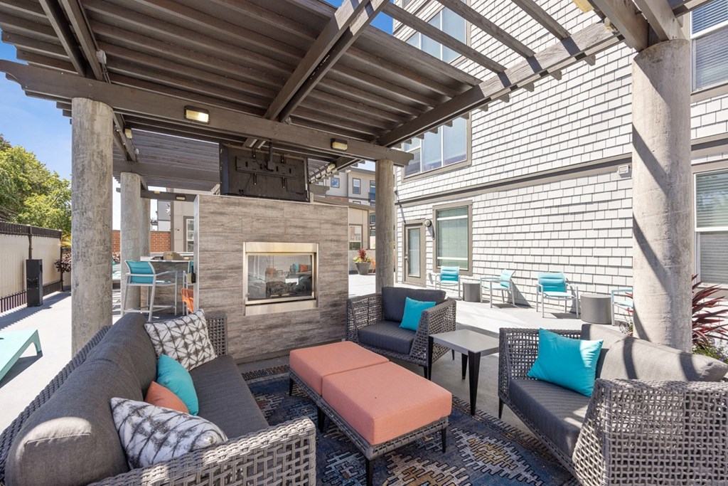 Covered Patio with Couches and Tables and a Fireplace at 45 Madison Apartments, Missouri, 64111