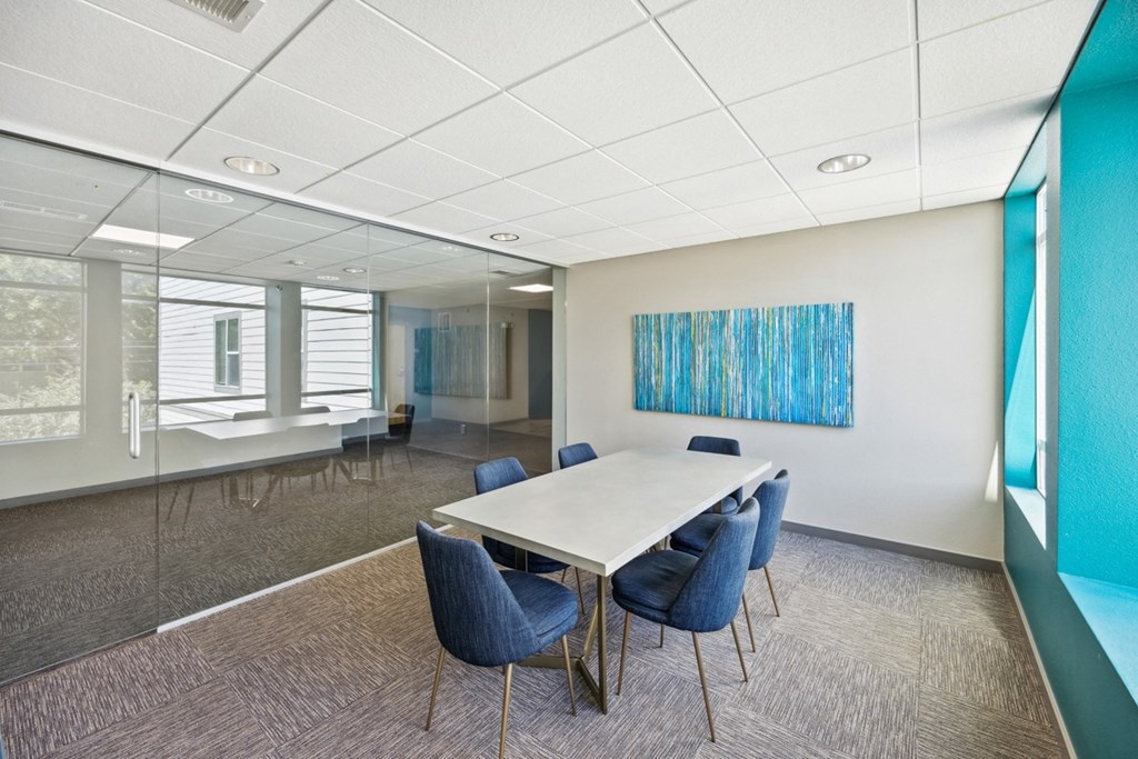 Conference Room with a White Table and Blue Chairs at 45 Madison Apartments, Missouri, 64111