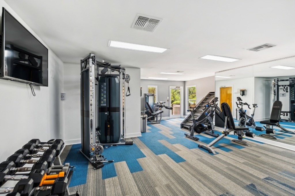 A gym with a variety of equipment including treadmills, weights, and exercise machines.at Chapel View, Chapel Hill