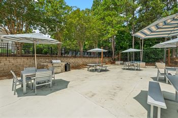 A park with benches and trees.