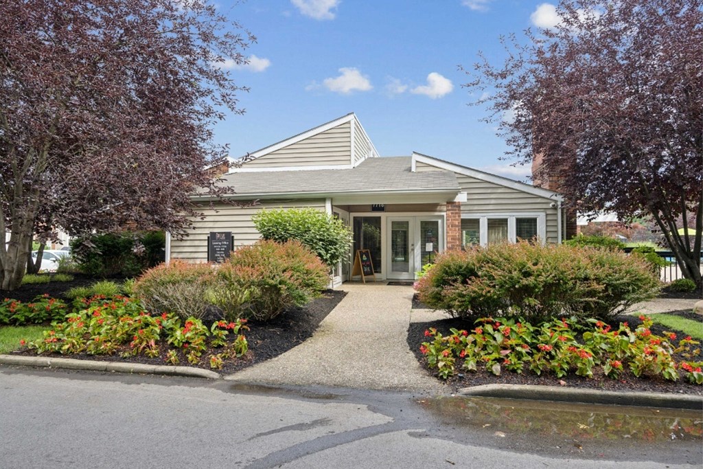 the front of a house with a driveway and landscaping