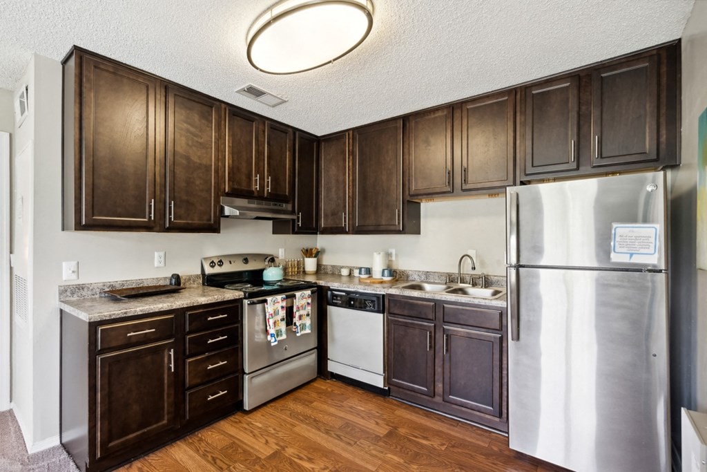 a kitchen with stainless steel appliances and wooden cabinets