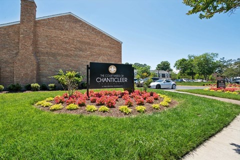 the church of the chancery sign in front of a flower garden