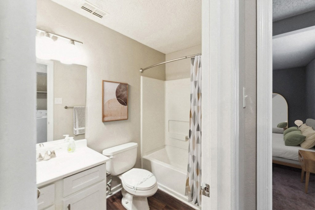 a bathroom with a shower and a toilet and a sink