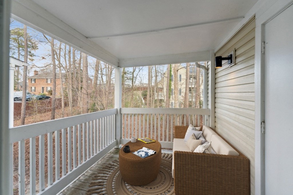 a porch with a couch and a table on it